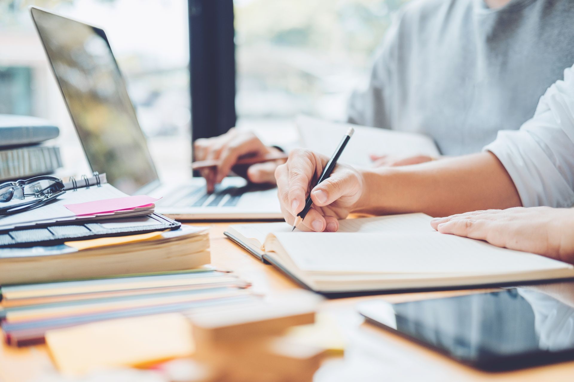 High school or college students studying and reading together in library High school or college students studying and reading together in library